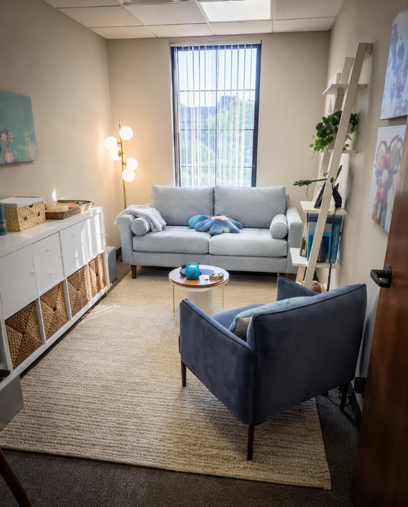 Comfortable counseling office with blue seating and soft lighting