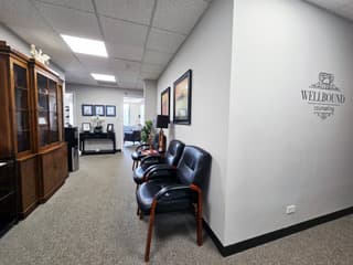 Office waiting area with seating and the Wellbound Counseling logo